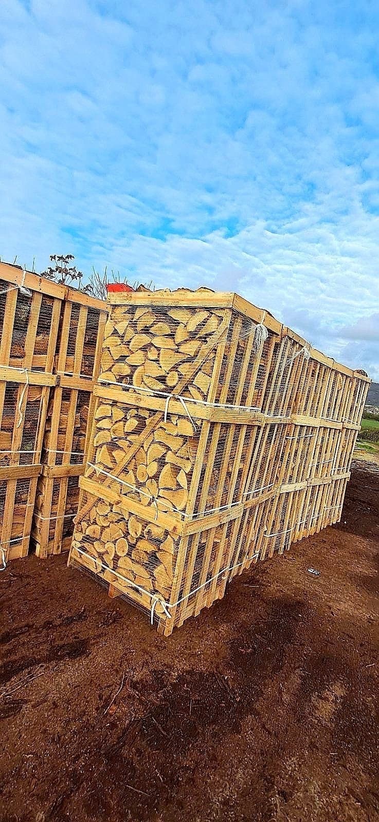 Stacked firewood crates in a rural yard setting