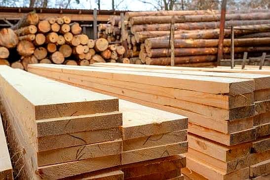 Sawn wood planks piled for various construction uses