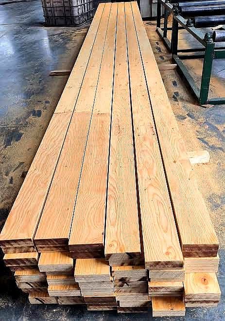 Seasoned timber planks in storage facility